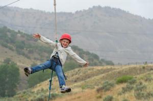 Camper Madison Stanley catches air on the challenge course at Roundup River Ranch in Avon, Colorado, in 2014. (Photo by William R. Edwards, provided by Roundup River Ranch)